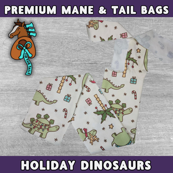 Main product image of Tip The Tails premium mane and tail bags made of high quality materials. This Christmas equine tail bag is titled Holiday Dinosaurs and features dinos in festive attire and holiday decorations on a light background.